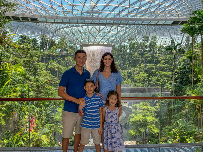 Our family in front of Changi Airport's Rain Vortex, the world's largest and tallest indoor waterfall.
